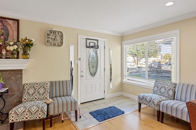 foyer entrance with ornamental molding and light tile patterned floors