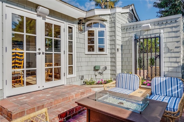 view of patio / terrace with a fire pit and french doors