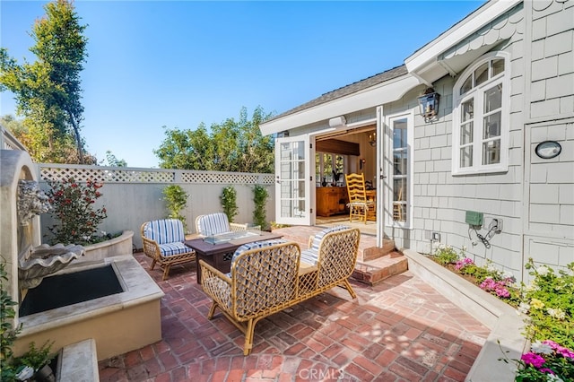 view of patio / terrace with an outdoor fire pit and fence