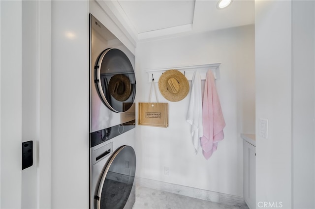 laundry area featuring stacked washer / drying machine and laundry area