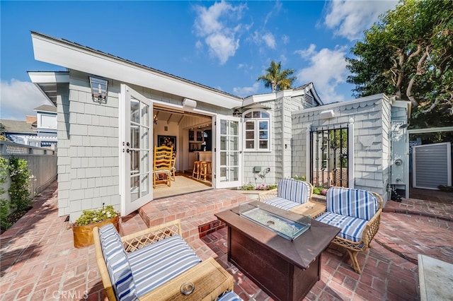 view of patio featuring french doors and an outdoor fire pit