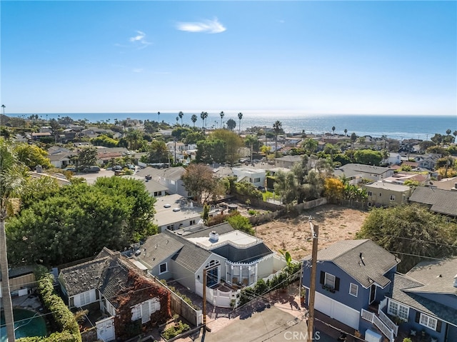 drone / aerial view with a water view and a residential view