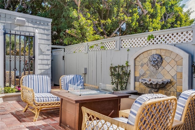 view of patio / terrace with a fire pit and fence