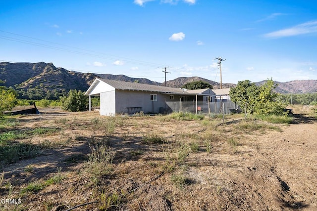 back of property with a mountain view