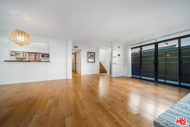 unfurnished living room featuring wood-type flooring