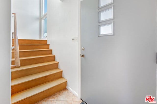 stairs featuring tile patterned flooring