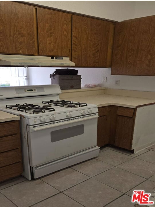 kitchen featuring tile patterned flooring and white range with gas stovetop