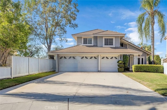 view of front of property with a front yard and a garage