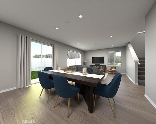 dining space featuring a wealth of natural light and light hardwood / wood-style flooring