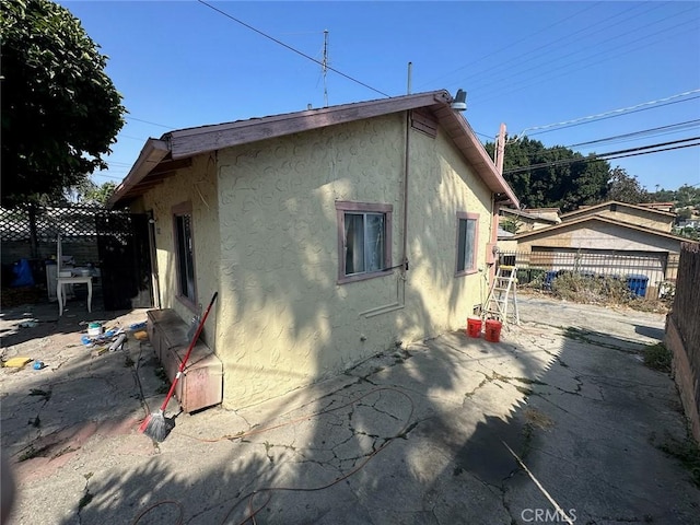 view of property exterior with a patio