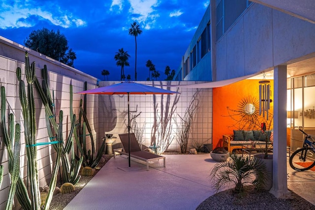 view of patio terrace at dusk