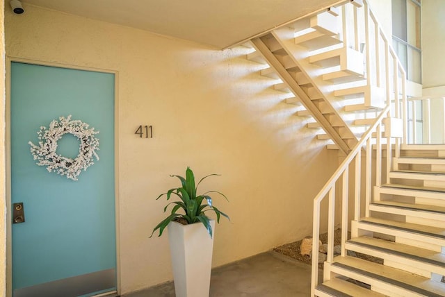 staircase with concrete flooring