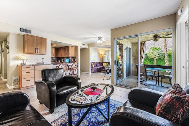 living room with light tile patterned floors and sink