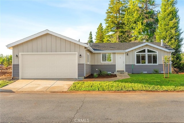 ranch-style house featuring a front yard and a garage