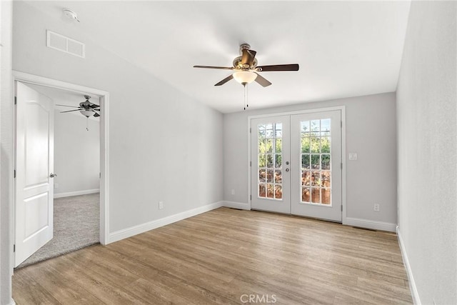 unfurnished room featuring ceiling fan, french doors, and light hardwood / wood-style flooring