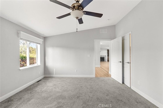 511 Montgomery, Paradise, CA 95969 - carpeted spare room featuring a ceiling fan, vaulted ceiling, and a fireplace