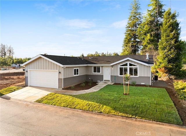 ranch-style home featuring a garage and a front lawn