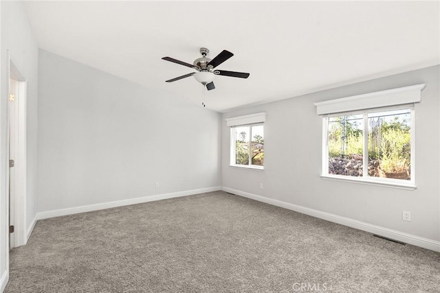 empty room featuring carpet flooring and ceiling fan