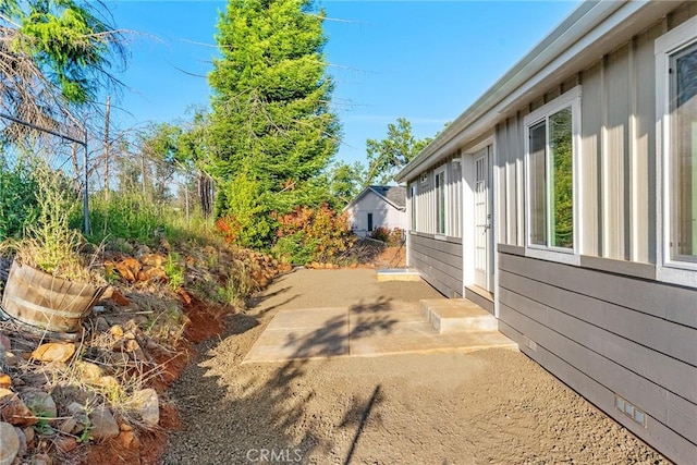 view of side of property with a patio area