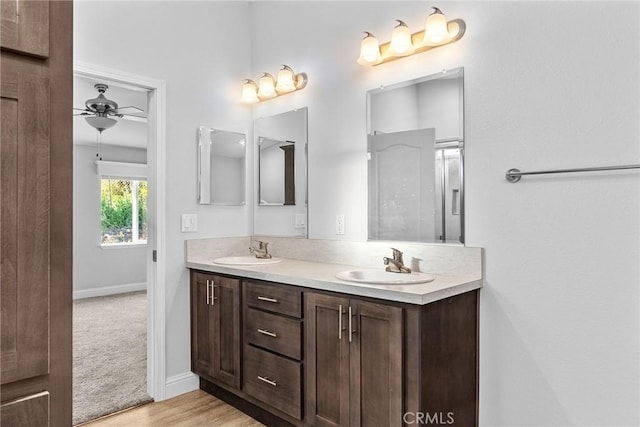 bathroom with hardwood / wood-style floors, vanity, and ceiling fan