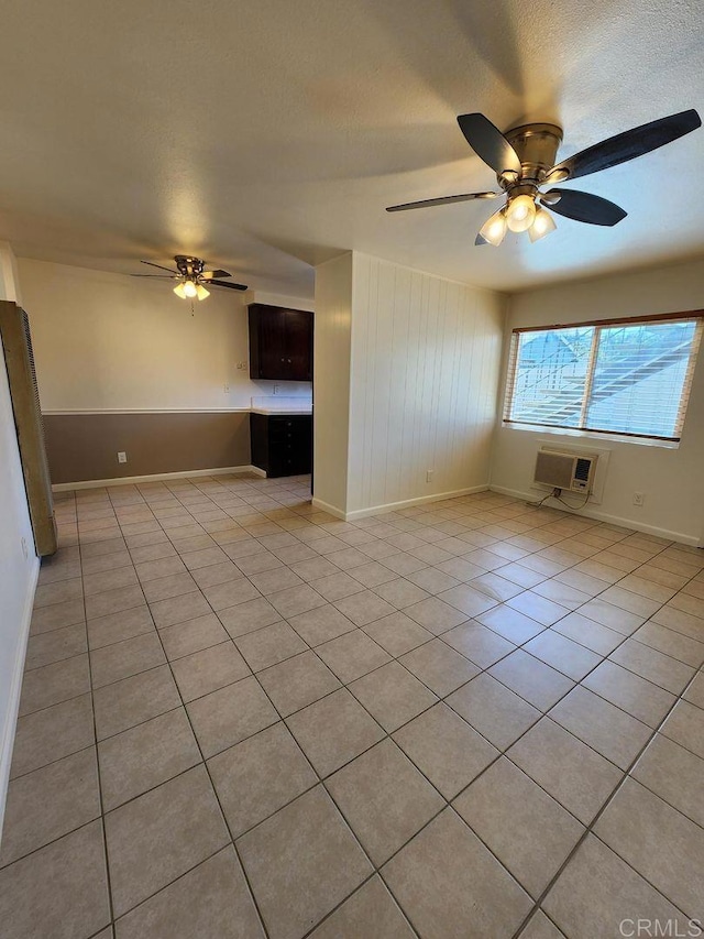 interior space featuring a wall mounted air conditioner, a textured ceiling, and ceiling fan