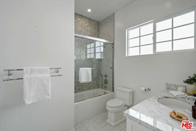 full bathroom featuring tile patterned floors, vanity, toilet, and enclosed tub / shower combo