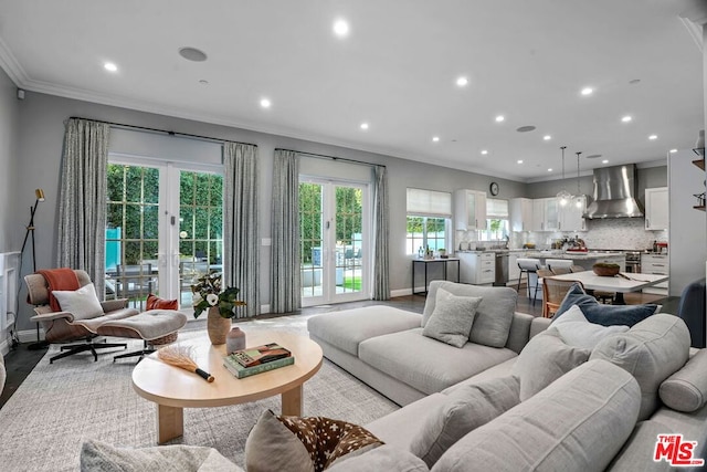 living room with light hardwood / wood-style floors and ornamental molding