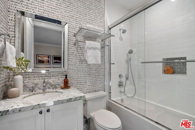 full bathroom featuring tasteful backsplash, bath / shower combo with glass door, vanity, crown molding, and toilet