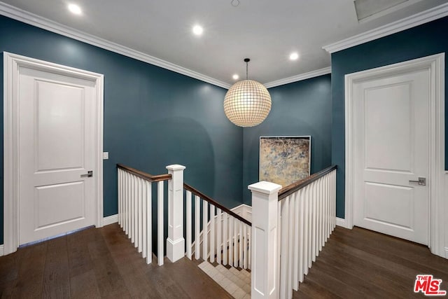 staircase featuring hardwood / wood-style floors and ornamental molding