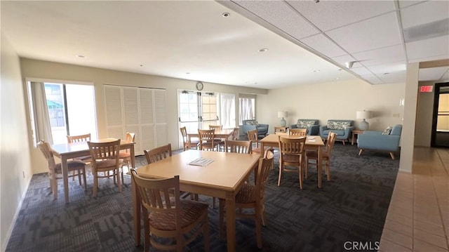 dining space with a paneled ceiling