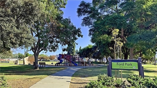 surrounding community featuring a playground and a yard