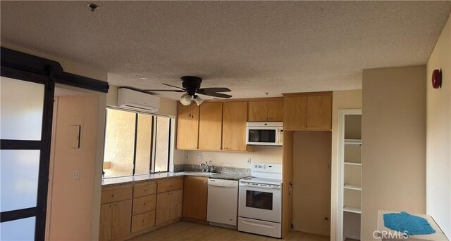 kitchen featuring ceiling fan, a wall unit AC, sink, white appliances, and a textured ceiling