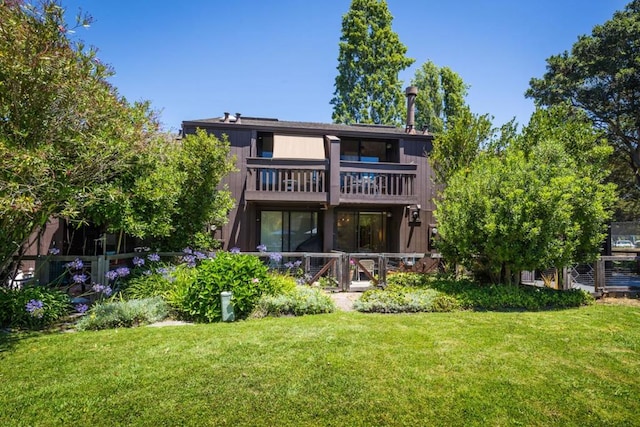 rear view of house with a lawn