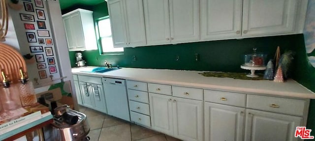 kitchen featuring white cabinets, light tile patterned flooring, sink, and white dishwasher