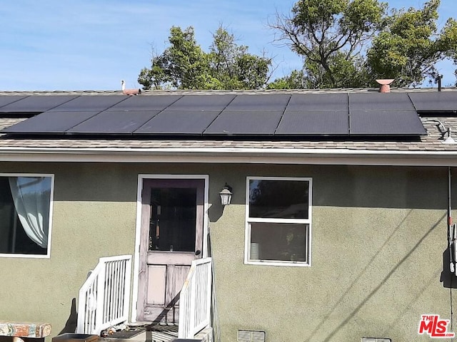 doorway to property with solar panels