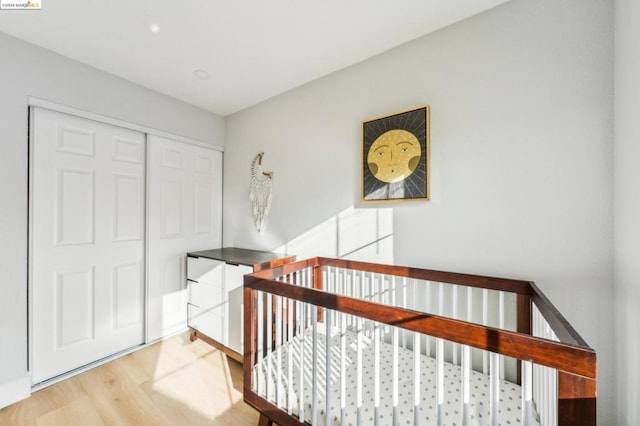 bedroom with hardwood / wood-style flooring and a closet