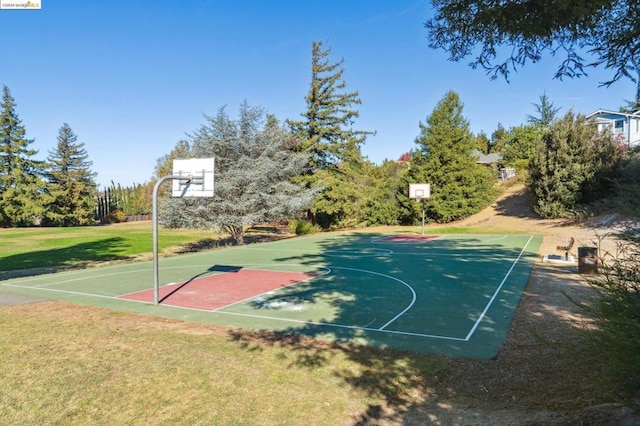 view of sport court featuring a lawn