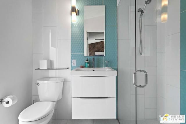 bathroom with vanity, toilet, and a shower with shower door