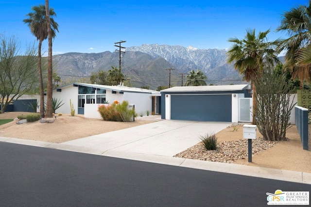 ranch-style home featuring a mountain view and a garage