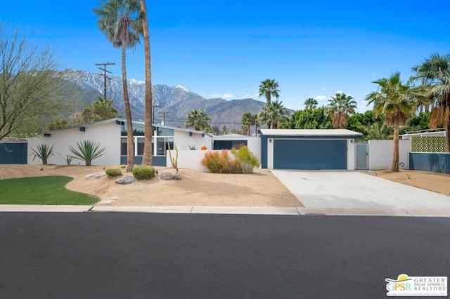 single story home with a mountain view and a garage