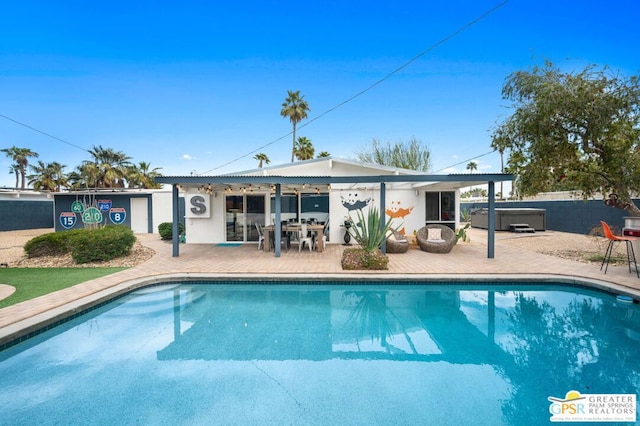 back of house featuring a patio area and a swimming pool with hot tub