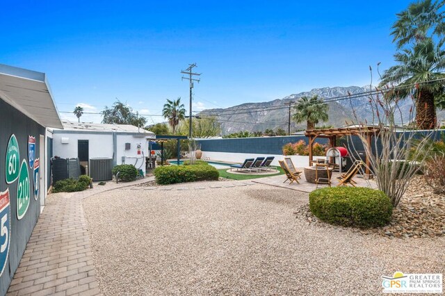 view of yard featuring a mountain view and a patio