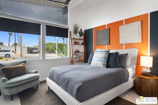 bedroom with carpet floors and beamed ceiling