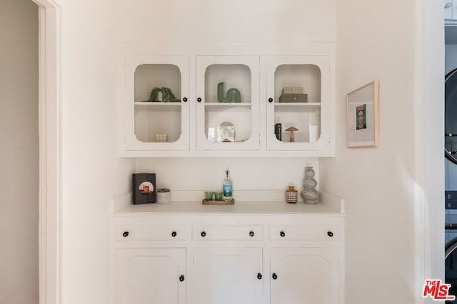 bar featuring white cabinets