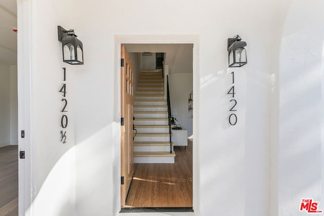 stairs with hardwood / wood-style floors