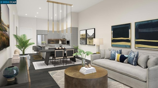 living room featuring hardwood / wood-style floors, a towering ceiling, and sink