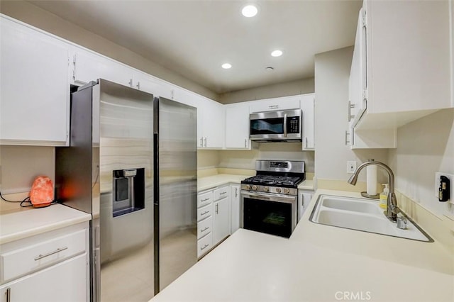 kitchen featuring white cabinetry, sink, and stainless steel appliances