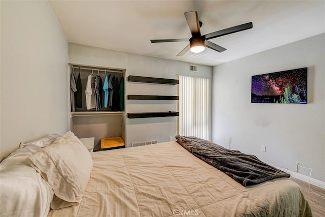 bedroom with hardwood / wood-style flooring and ceiling fan