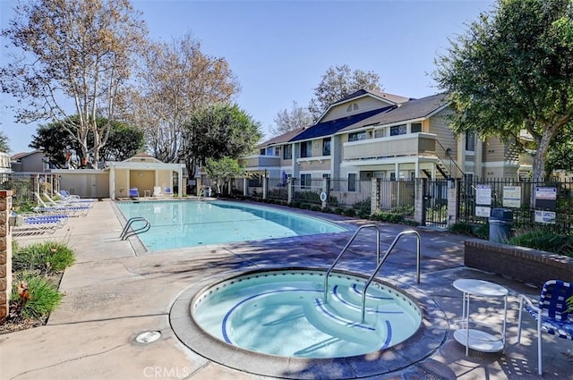 view of pool with a community hot tub and a patio