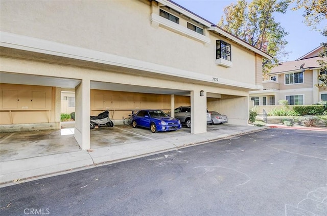 view of vehicle parking featuring a carport